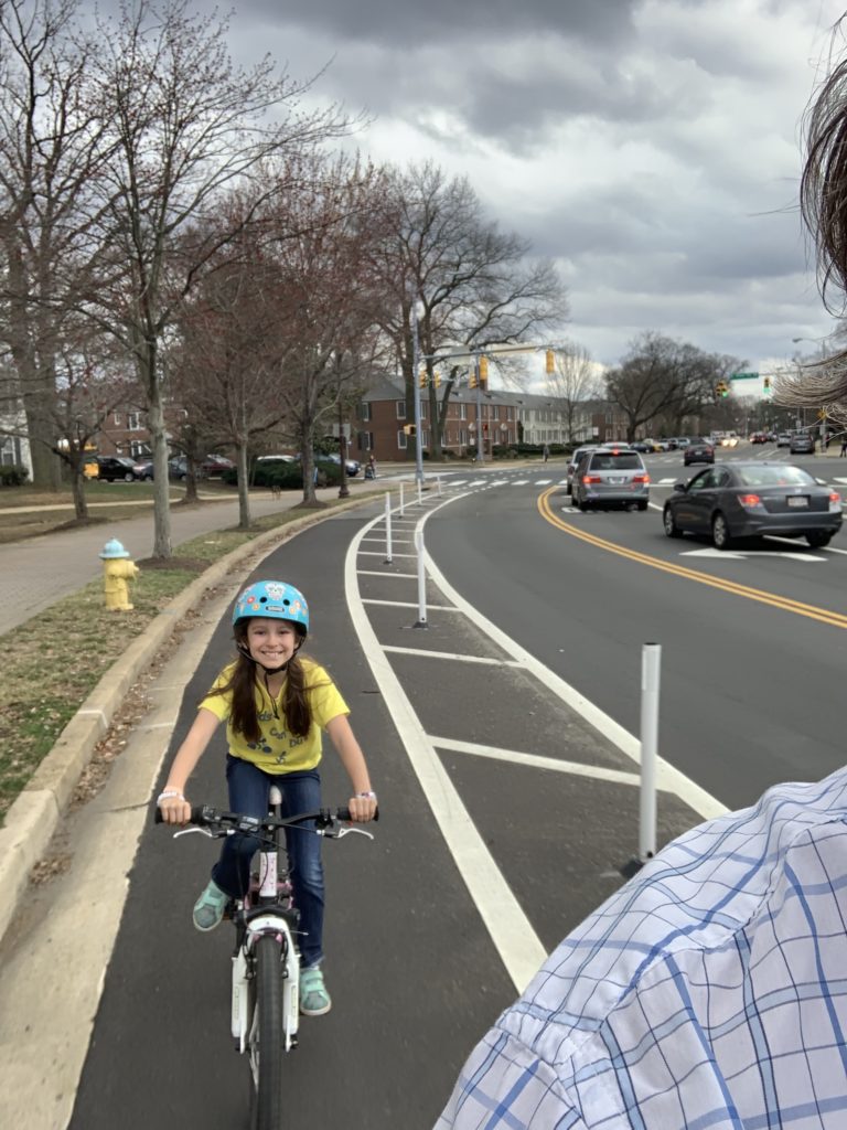 Child riding on a bike in the Quincy Street protected bike lane in Arlington, Virginia